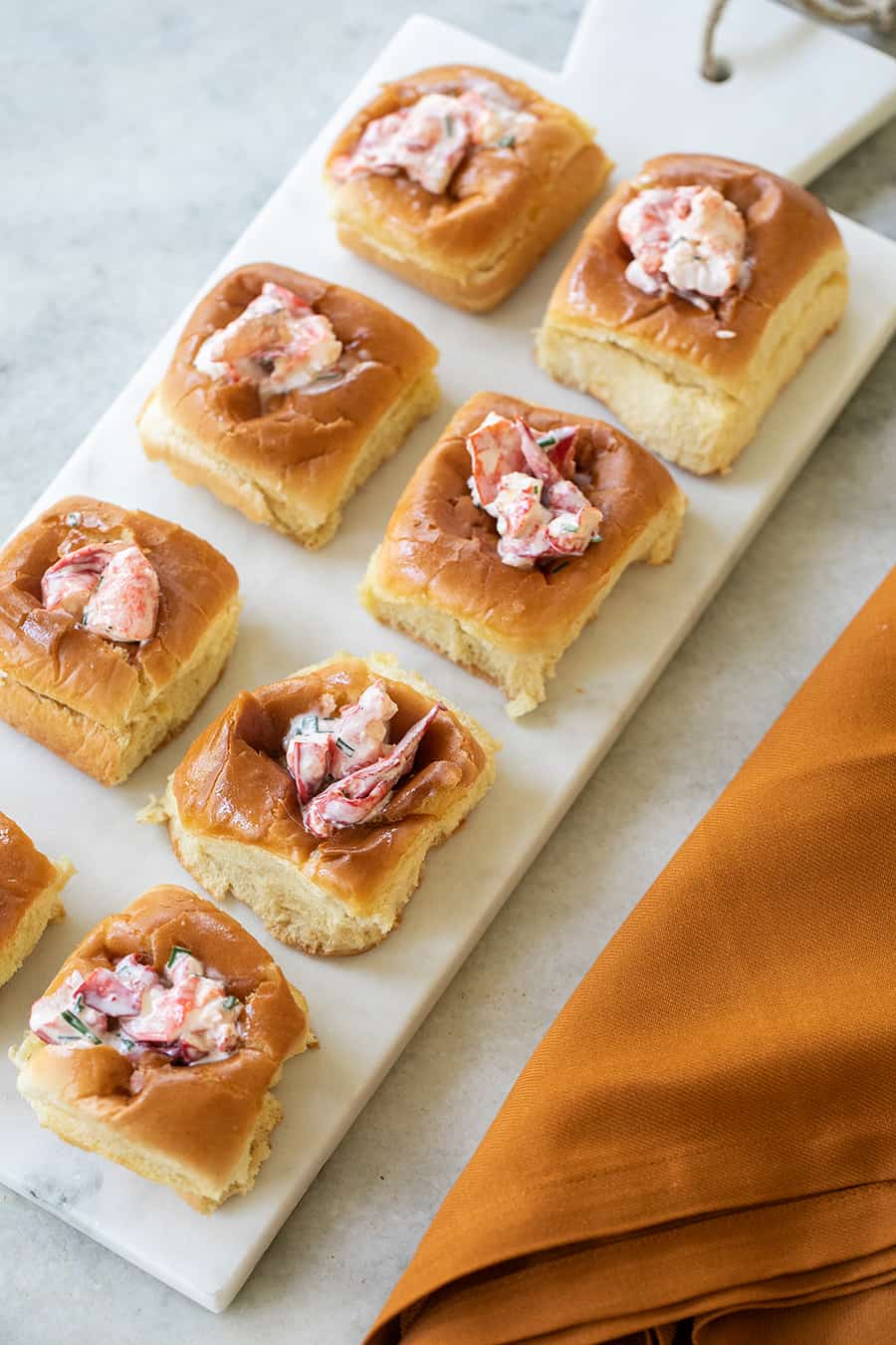 Mini lobster rolls on a marble tray