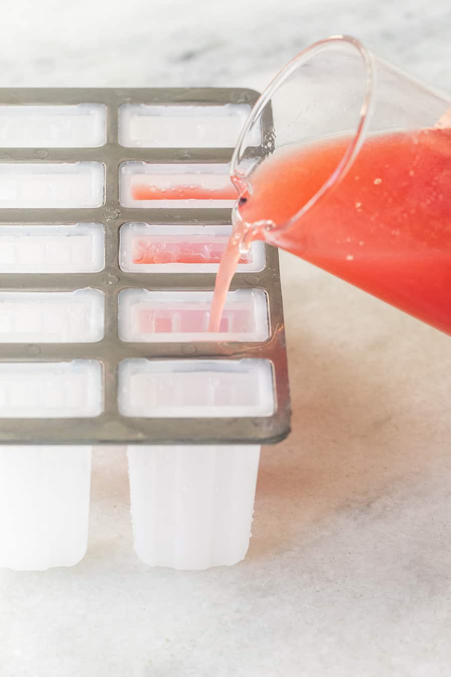 Negroni popsicles poured into a popsicle mold