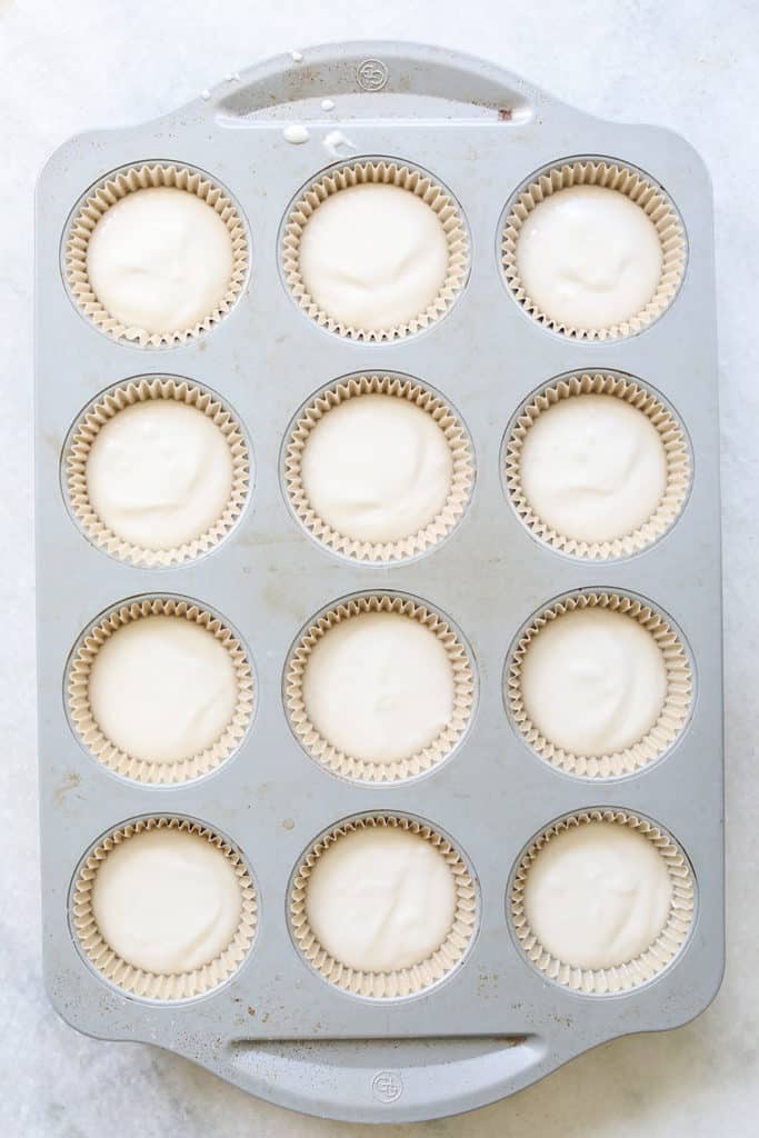 White vanilla cupcakes in brown paper cupcake liners
