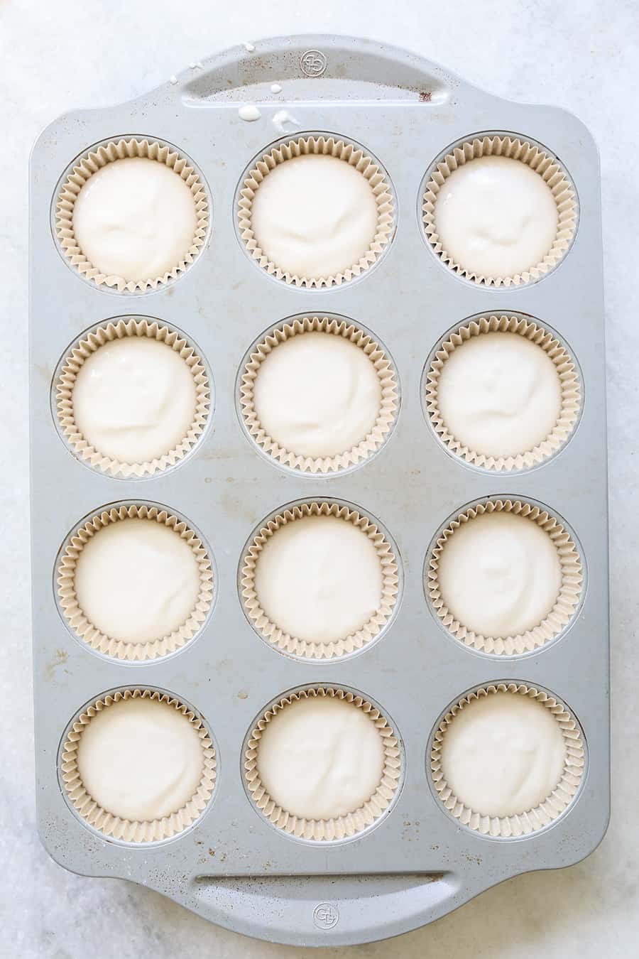 White vanilla cupcakes in brown paper cupcake liners