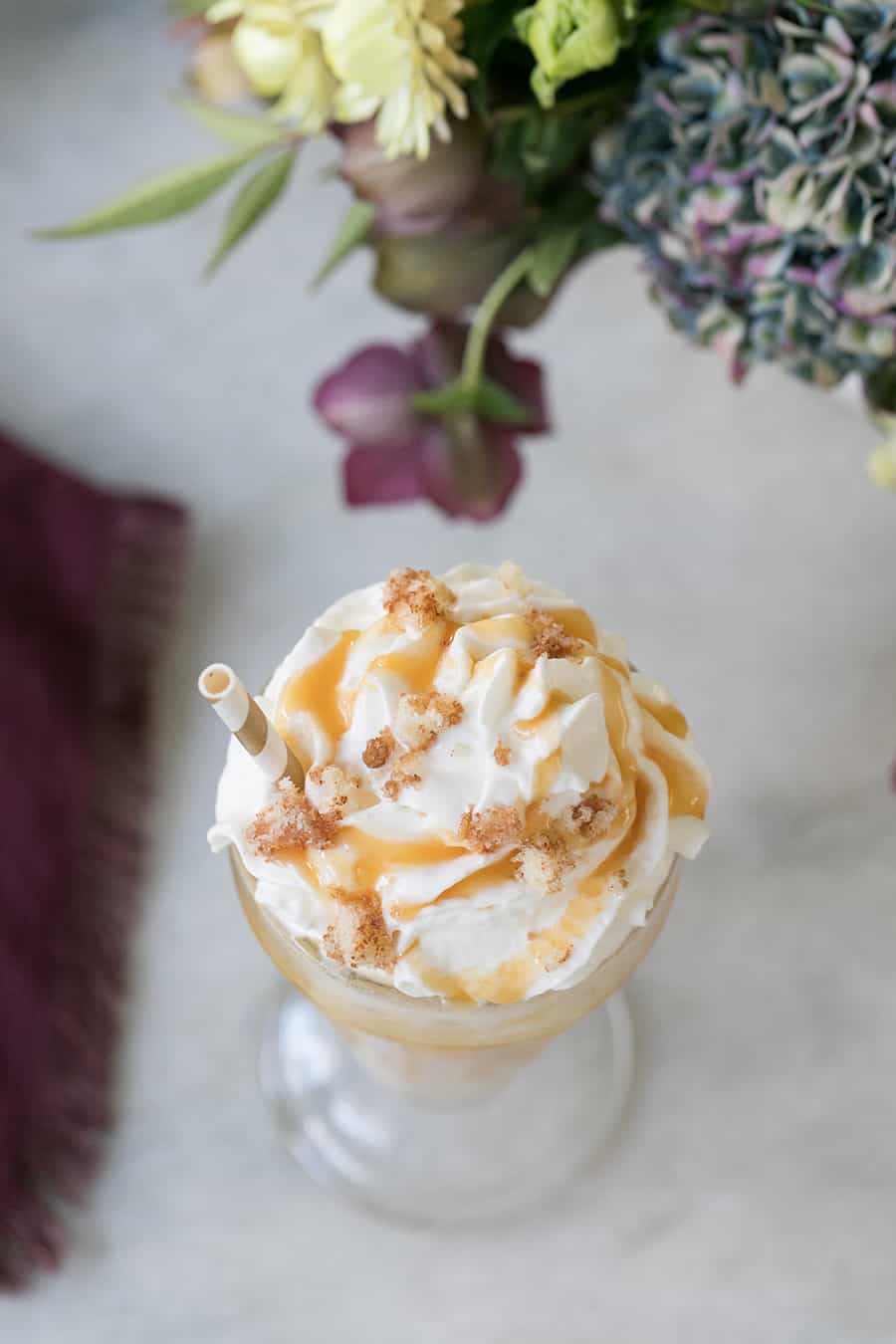 caramel milkshake with drizzled caramel and coffee cake crumbs