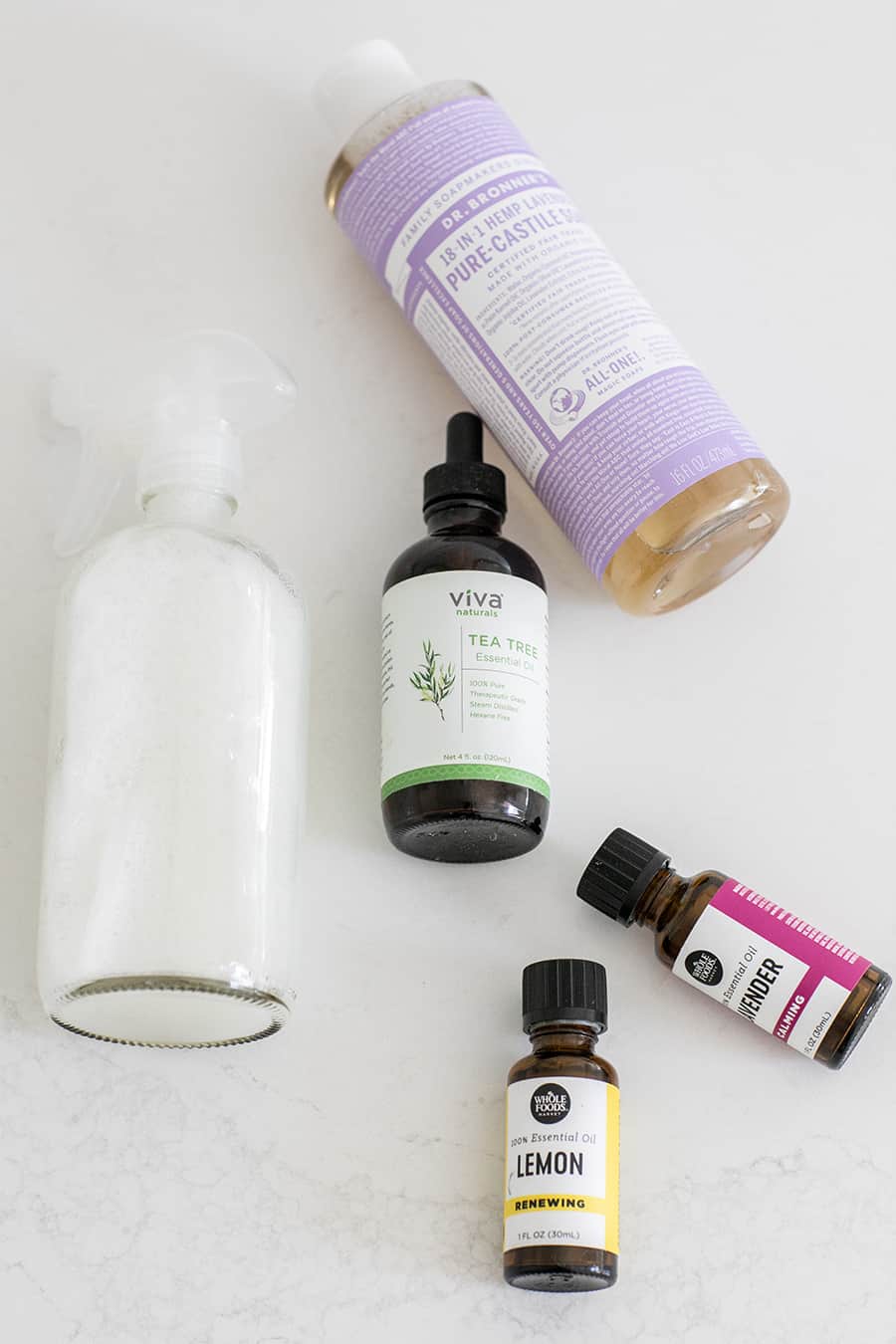 Lavender Essential Oil, Lemon Essential Oil, Tea Tree Oil, Castile Soap and a Clear Spray Bottle for Making DIY Cleaning Products