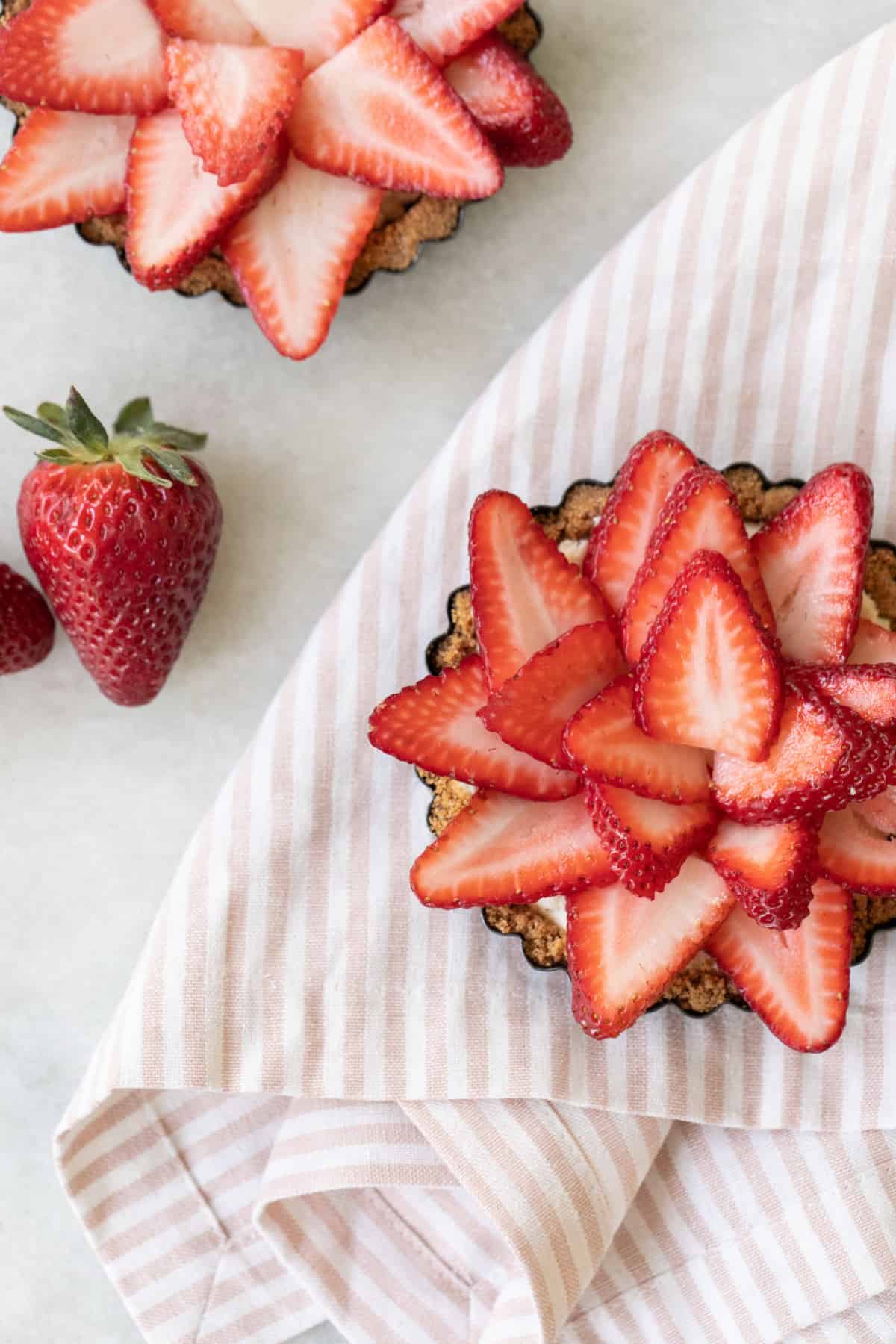 strawberry pies with a pink striped napkin