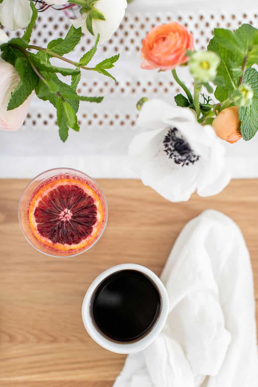 Coffee and mimosas on a wooden table.