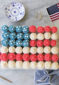 overhead photo of American flag made out of cupcakes