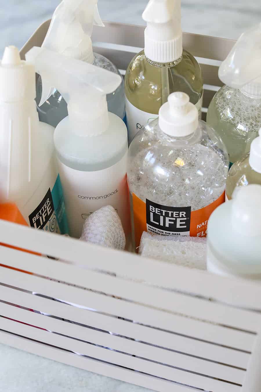Natural cleaning products in a basket for a healthier cleaning kit.