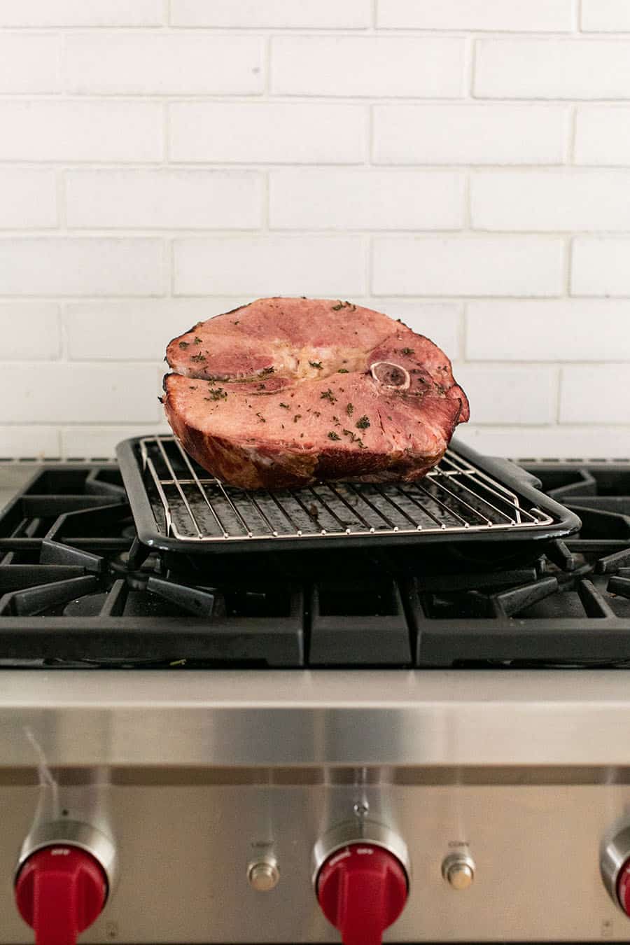 cooked ham sitting on an oven pan. 