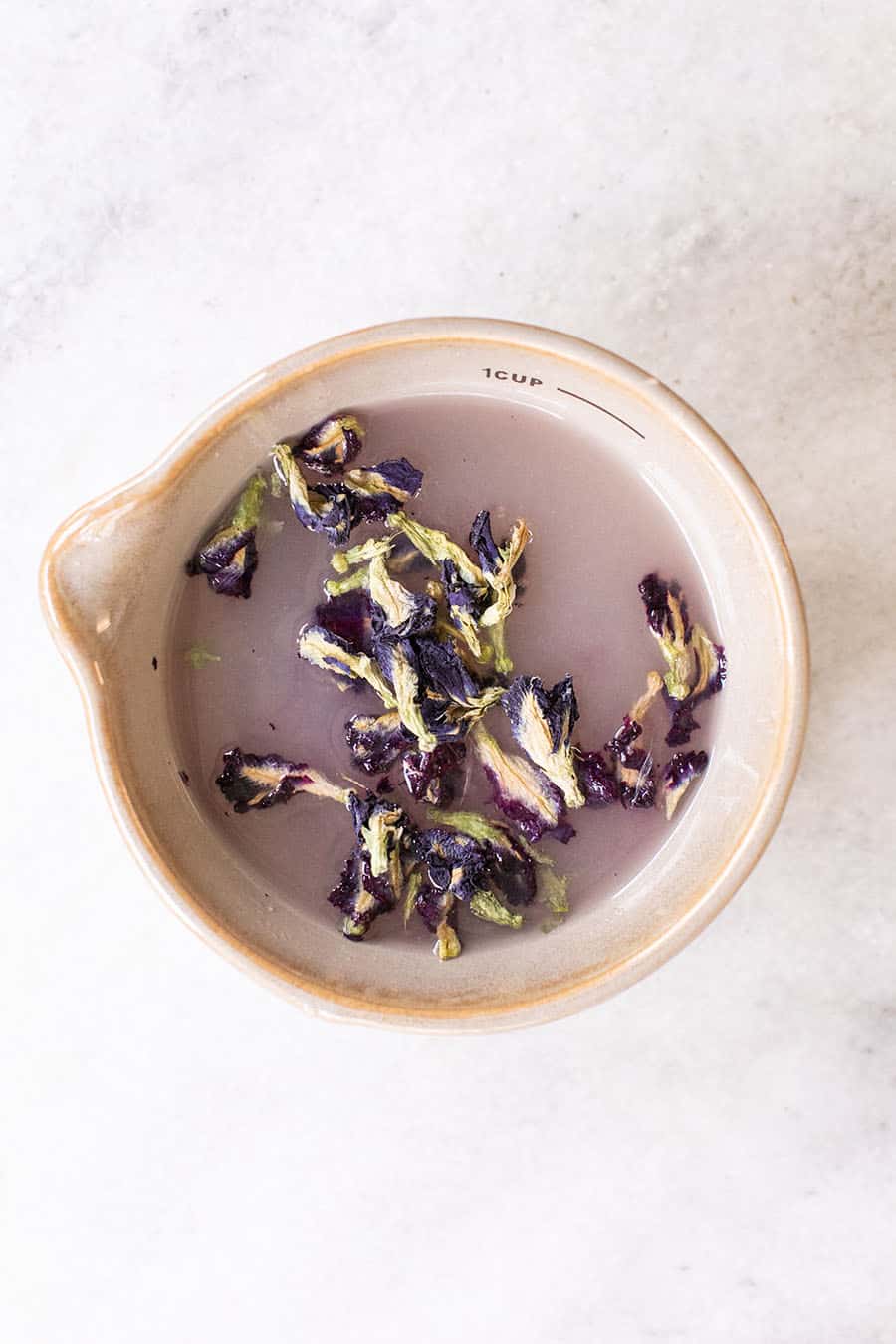 butterfly pea flowers in lime juice 