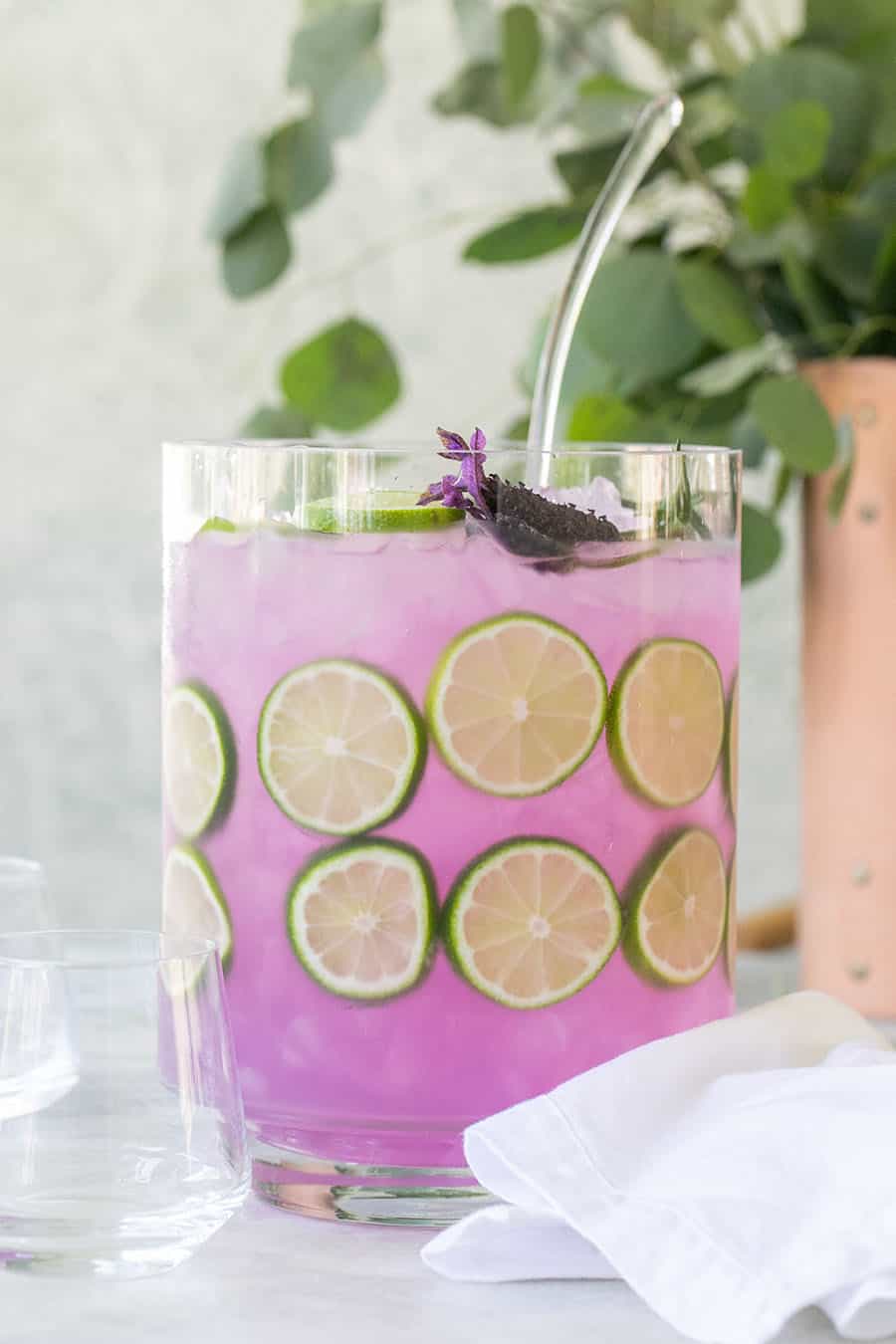 gin and tonic punch in a punch bowl with lime slices