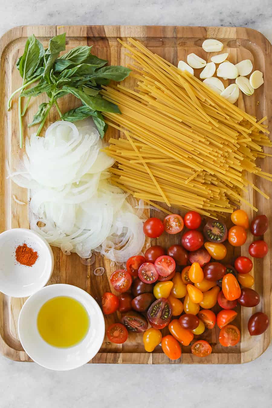 Ingredients for one pot pasta recipe like onion pasta, tomato and basil - tomato basil pasta