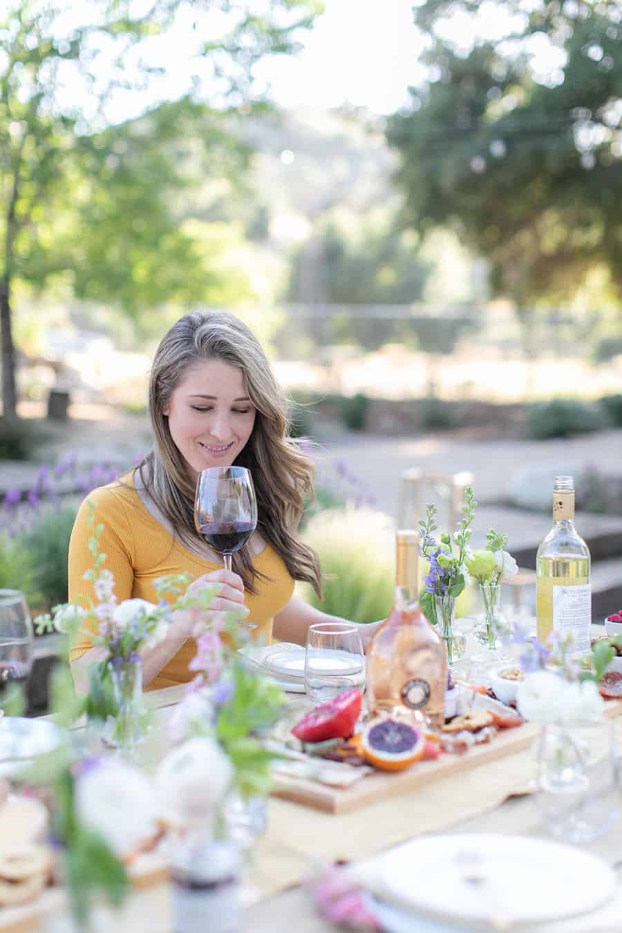 Eden Passante in her backyard sipping wine. 