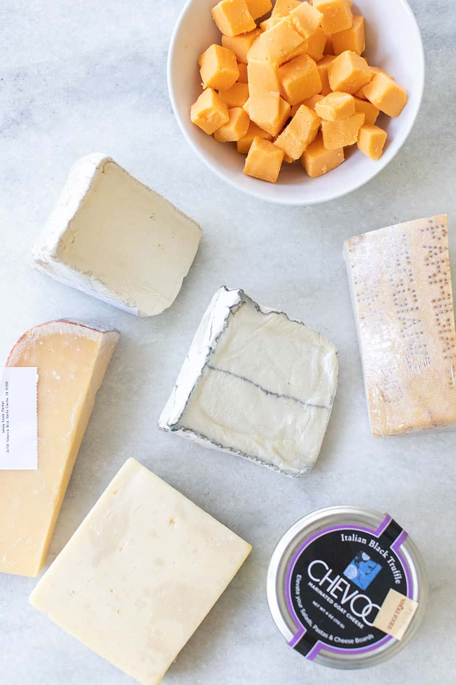 Overhead of different cheeses for cheese board. 