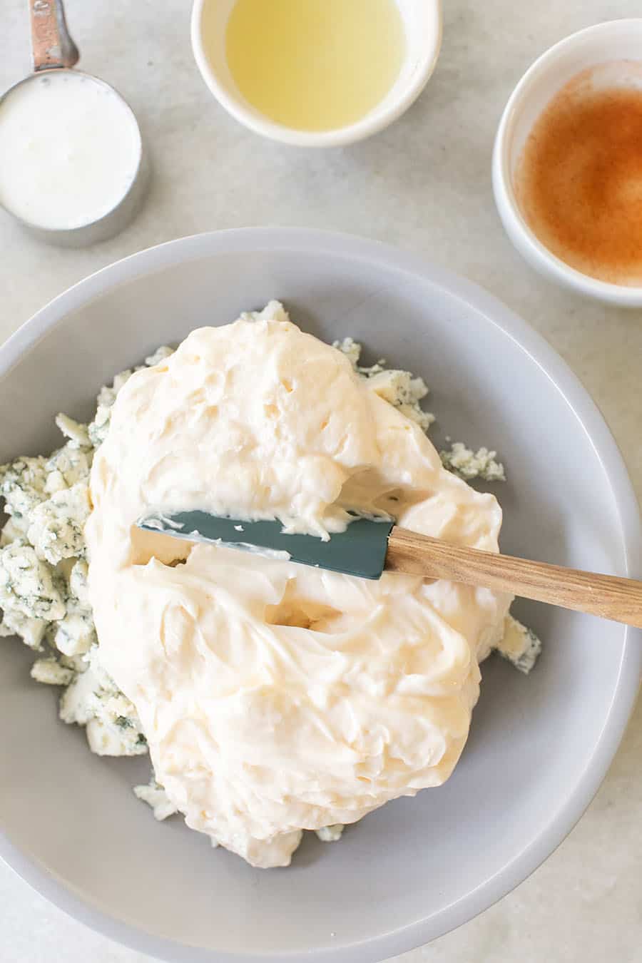 Homemade blue cheese dressing in a bowl with a spatula. 