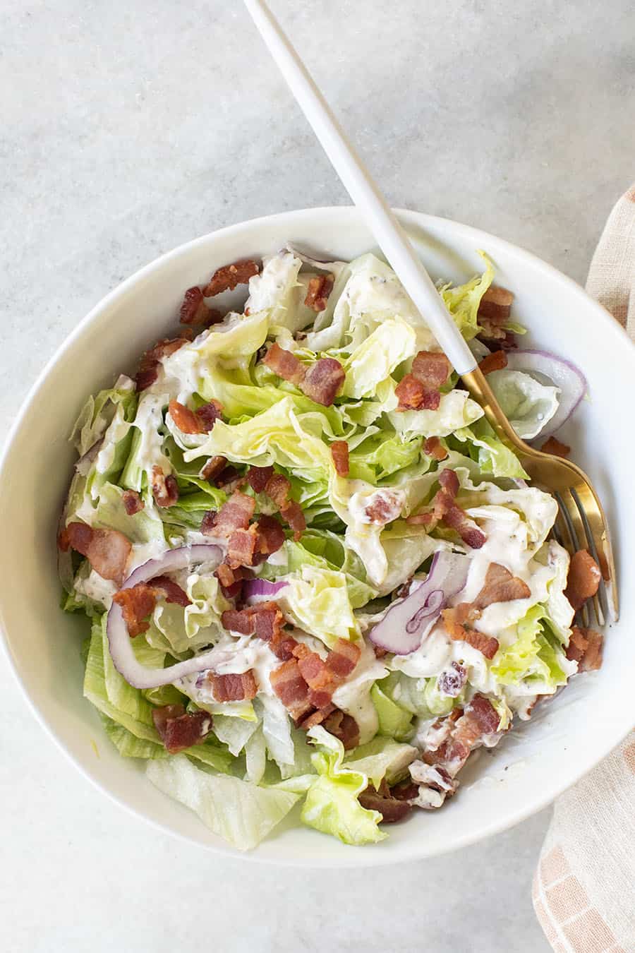 Wedge salad chopped in a white bowl. 