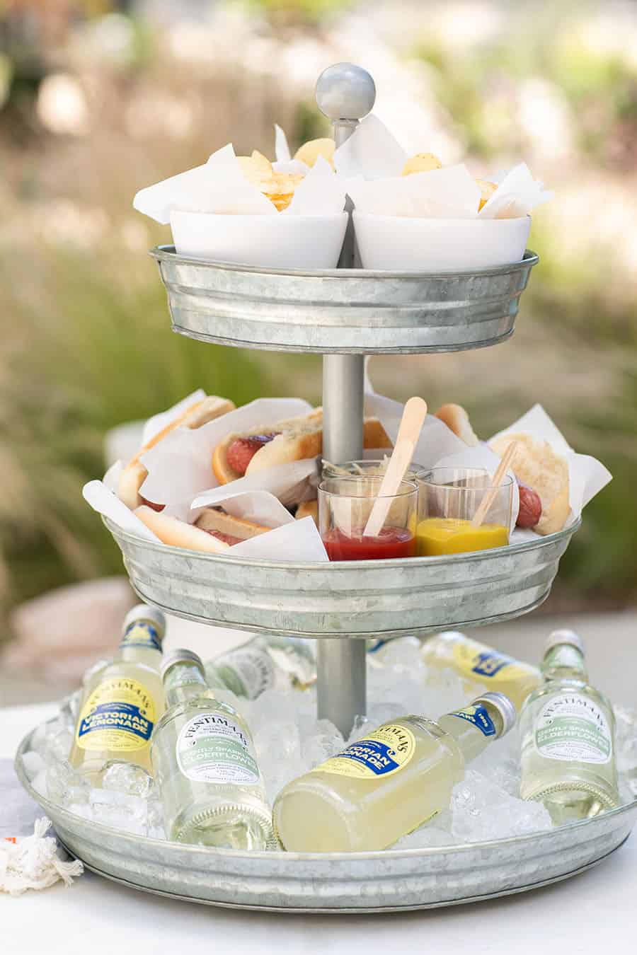 Tiered Galvanized Tray with potato chips, hot dogs and sodas on the bottom