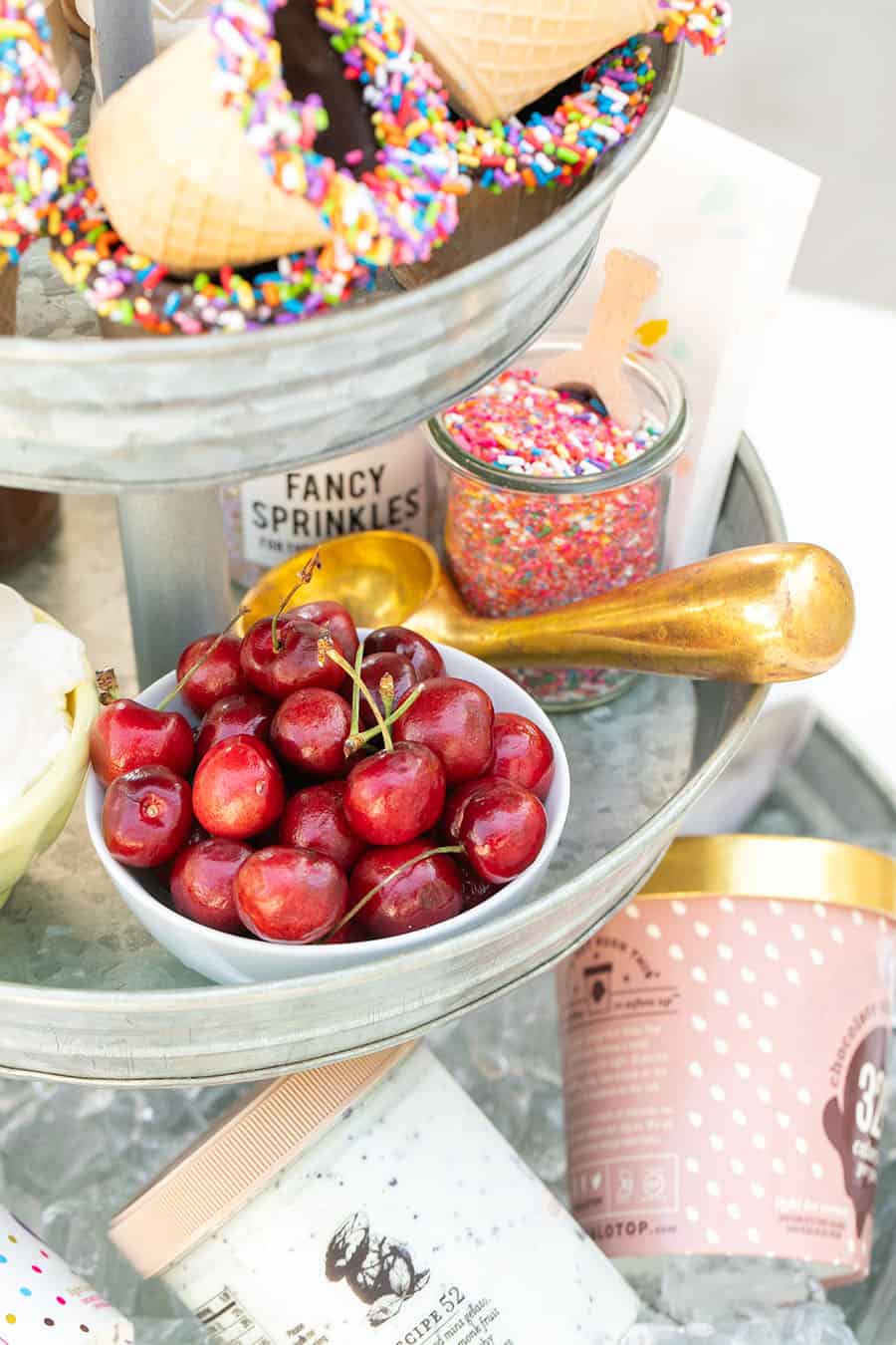 Tiered Galvanized Tray with cherries in white bowl and copper ice cream scooper. 