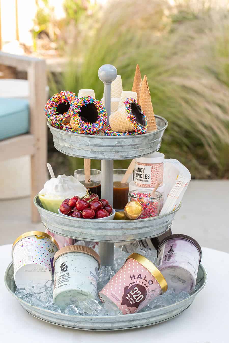 Tiered Galvanized Tray with ice cream cones on top. cherries and toppings in the center and ice cream on the bottom.