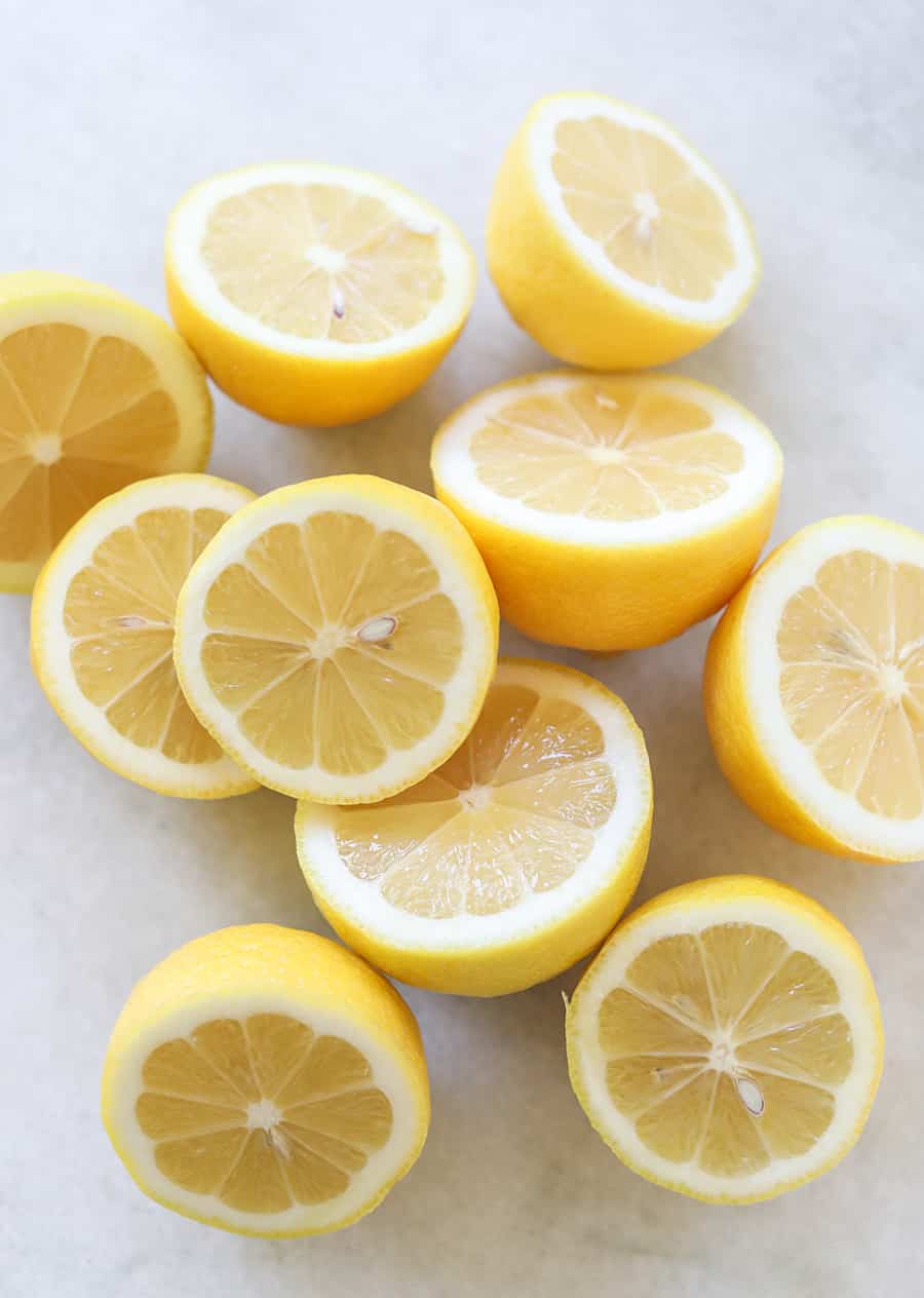 Lemons cut in half on a marble table. 