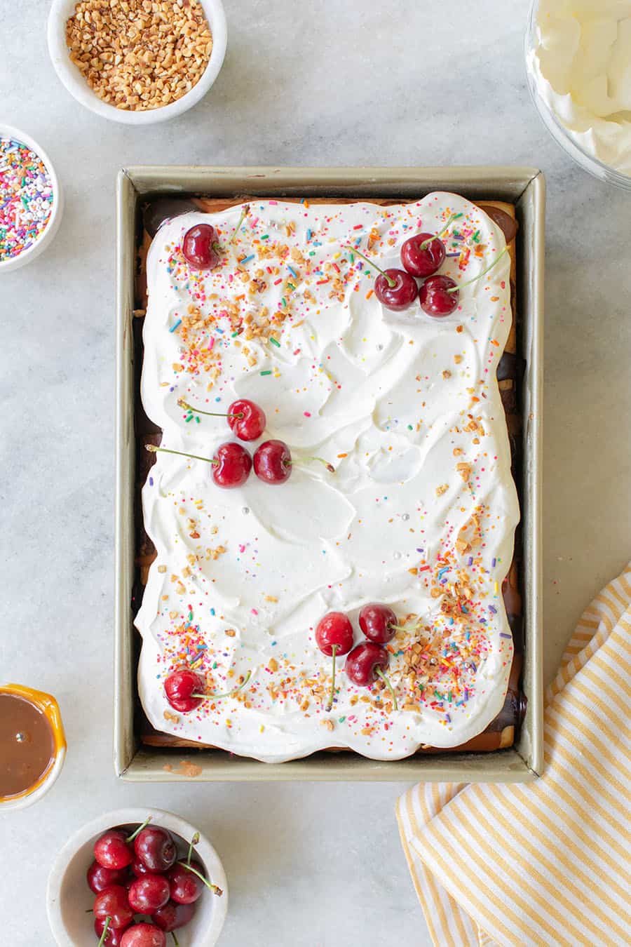 Ice cream sundae cake with cherries and tomatoes. 