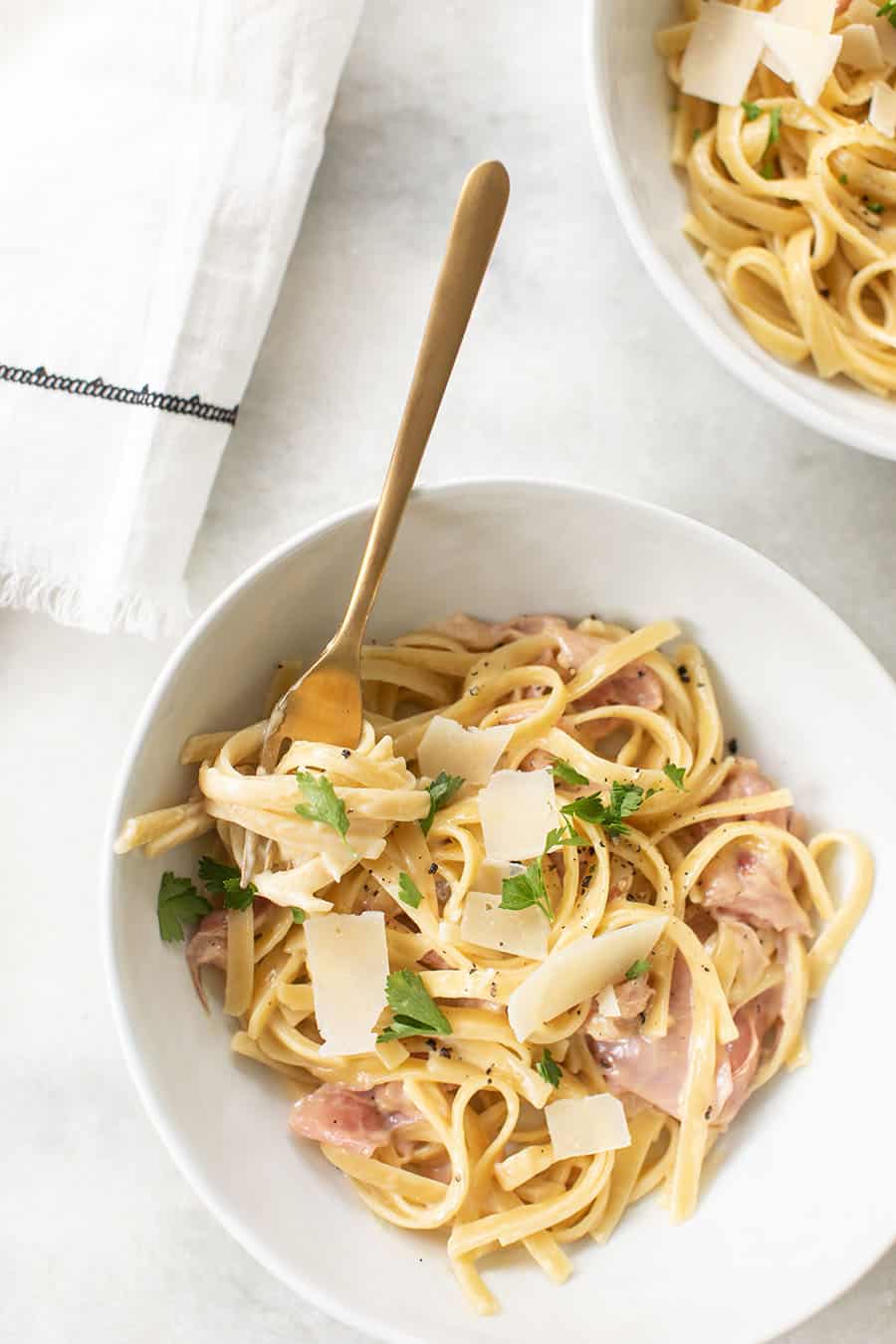 Bowl of One Pan Fettuccine with Prosciutto with gold spoon.