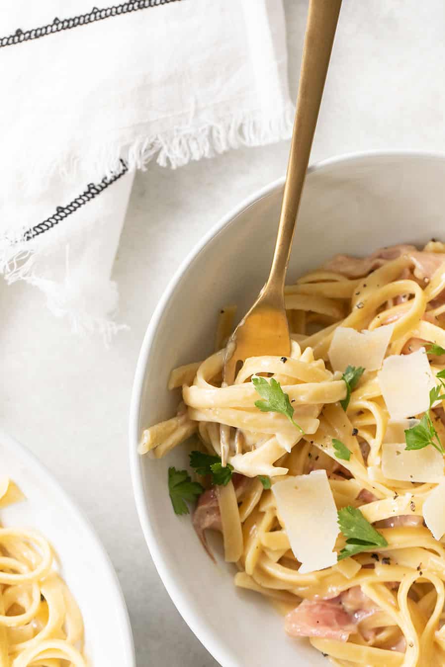 One Pan Fettuccine with Prosciutto with fork and cheese.