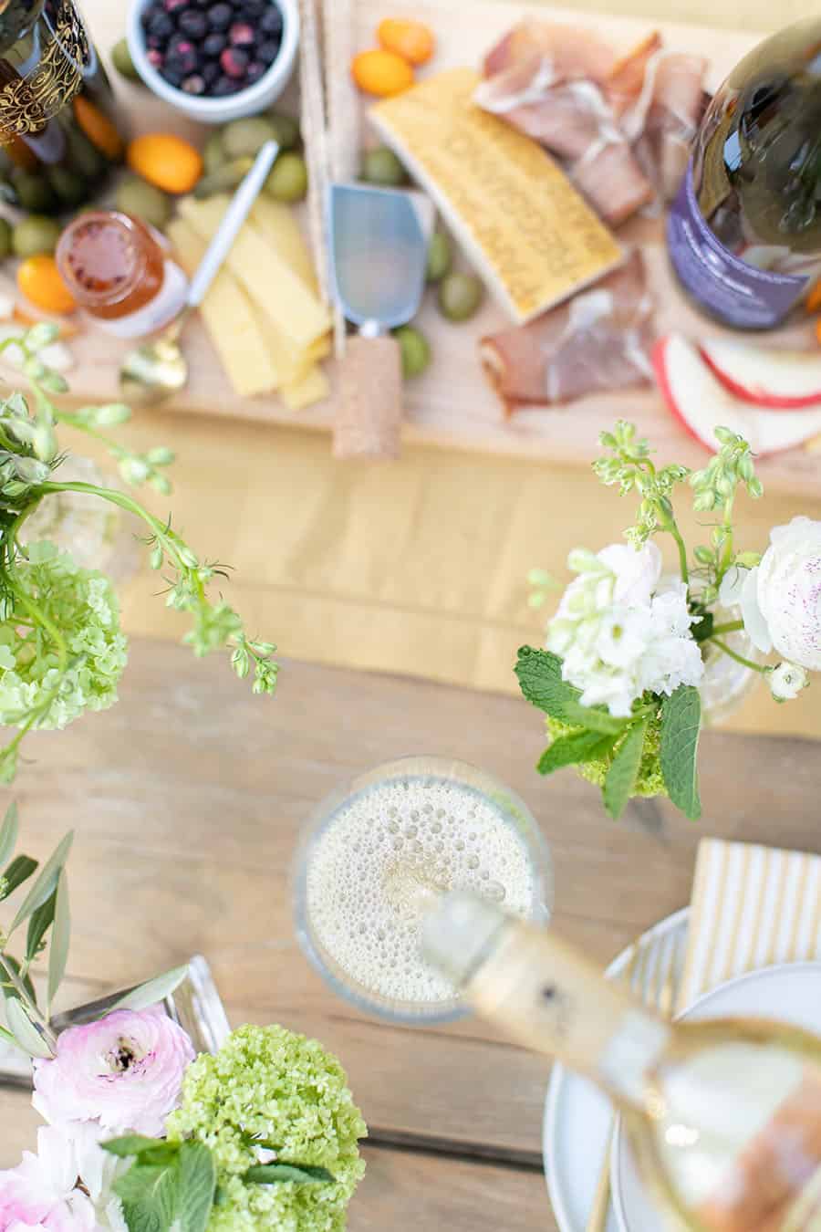 overhead photo pouring white wine in a wine glass