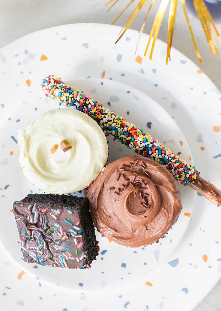 Cupcakes and pretzel stick on a pretty plate. 