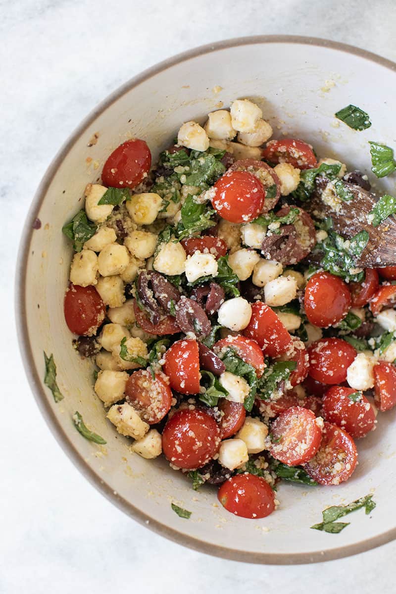 Summer Pasta Salad Recipe with tomatoes, olives, garlic, cheese and basil.