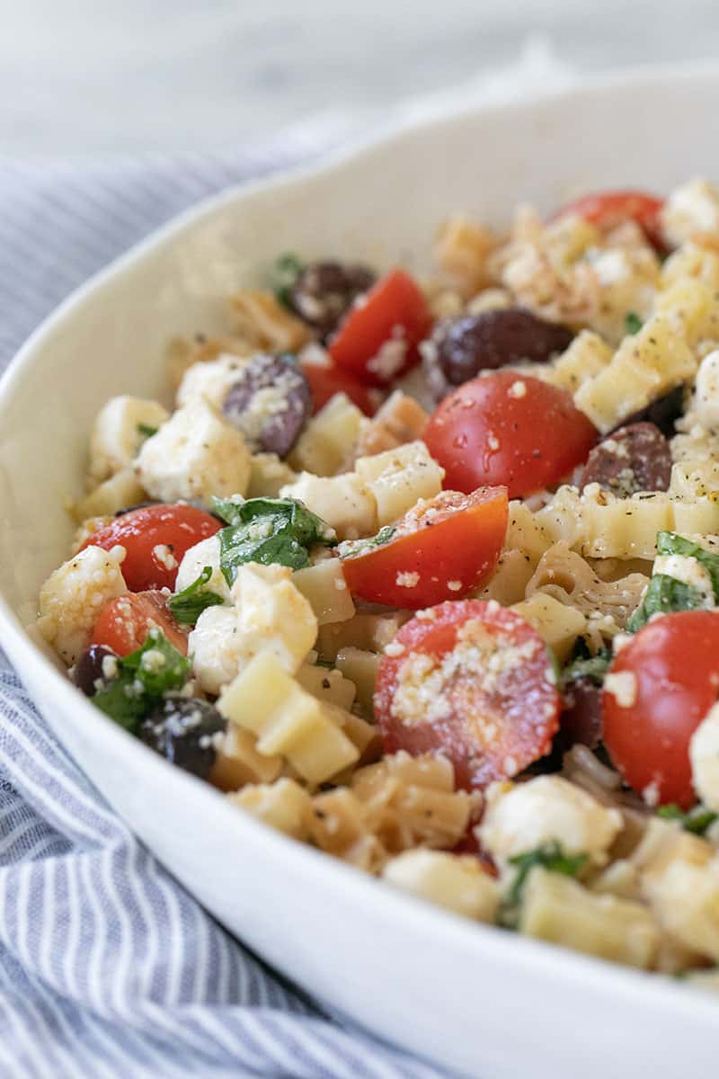 Summer Pasta Salad Recipe with tomatoes, olives, garlic, cheese and basil.