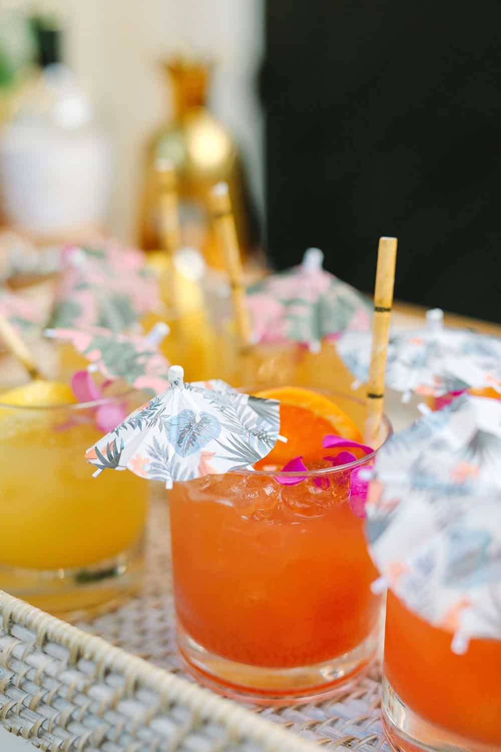 Tropical cocktails with cocktail umbrellas and bamboo straws.