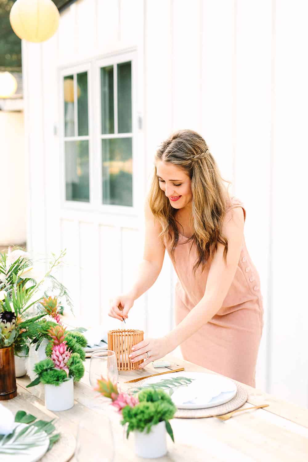 Eden Passante lighting a candle for a tropical party