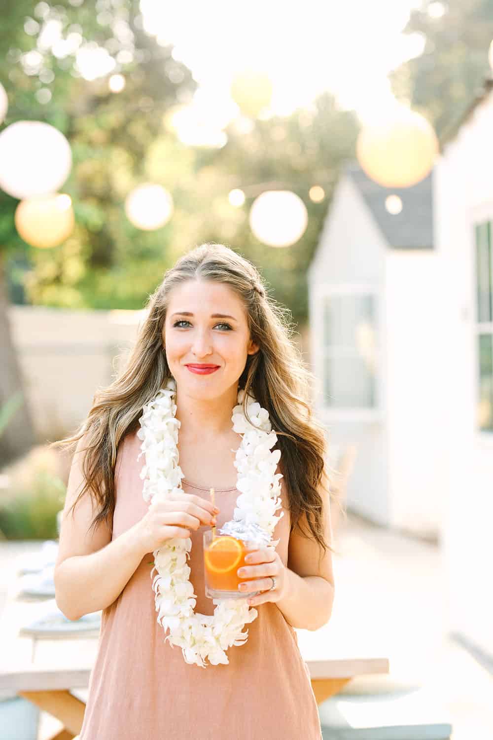 Eden Passante of Sugar and Charm wearing a fresh lei for her tropical party.