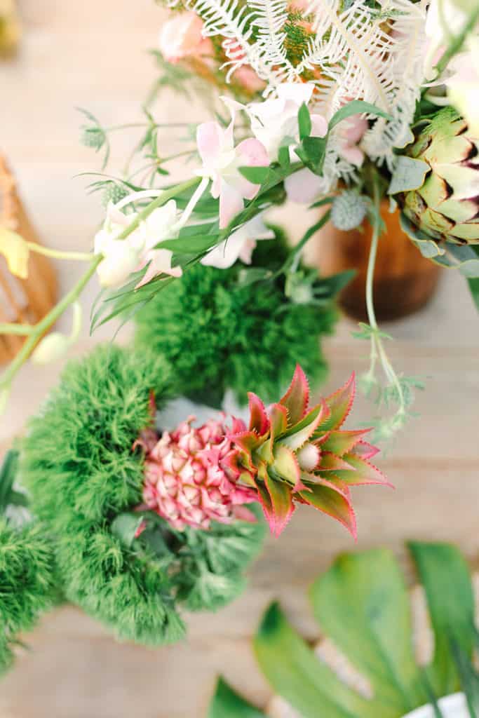 Mini pink pineapple and tropical flowers.