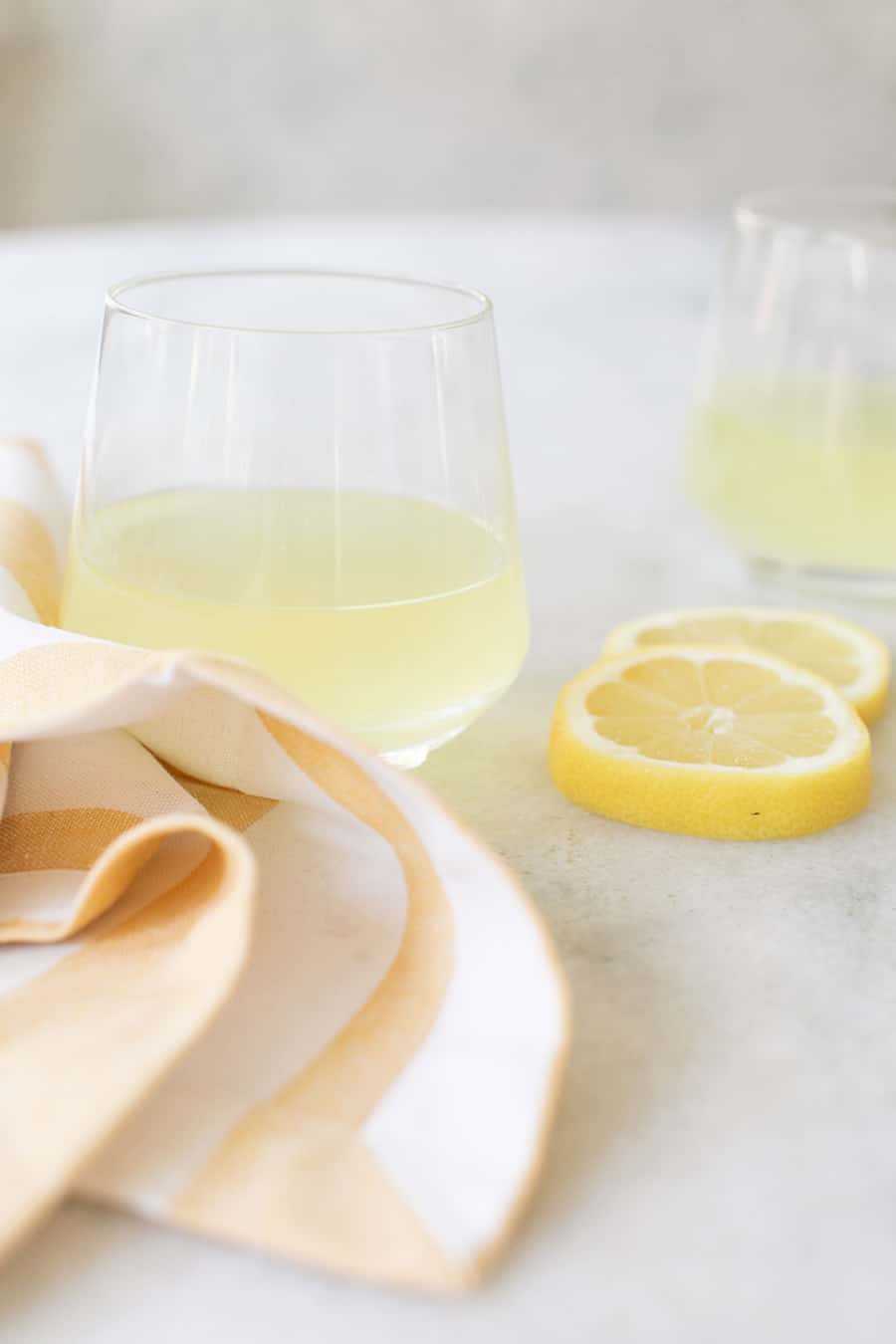 Limoncello in a glass with lemon slices.