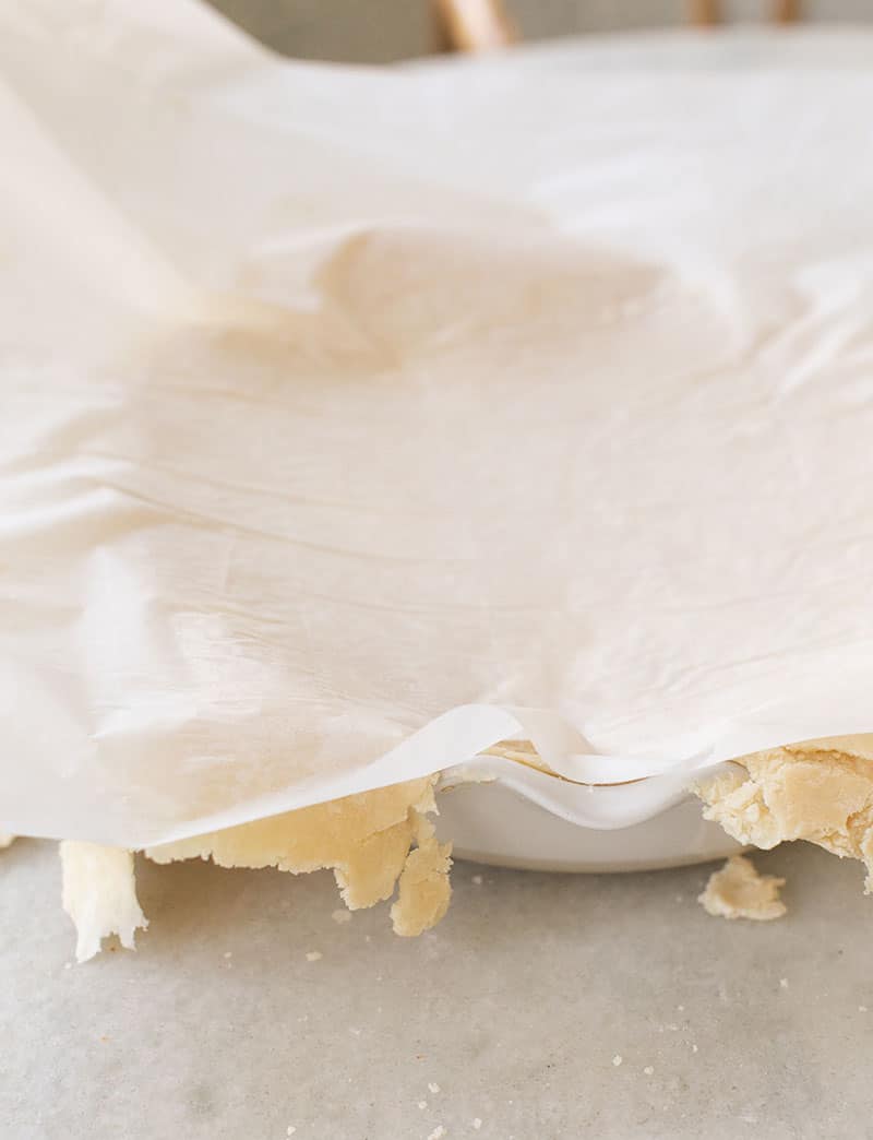 Pie crust being flipped into a pie dish 