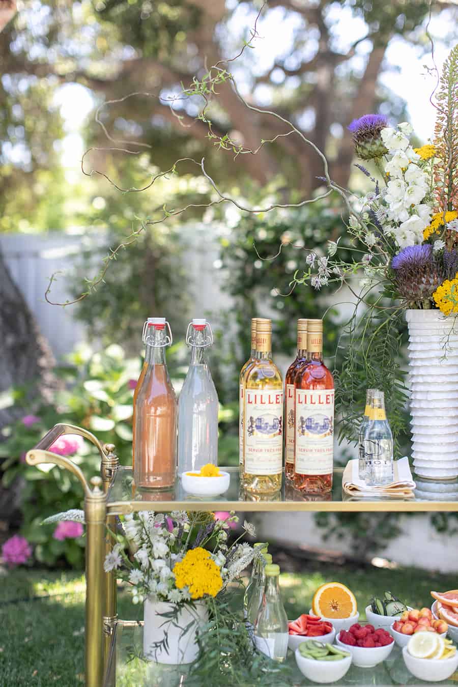 Lillet on bar cart with sparkling lemonade and berries