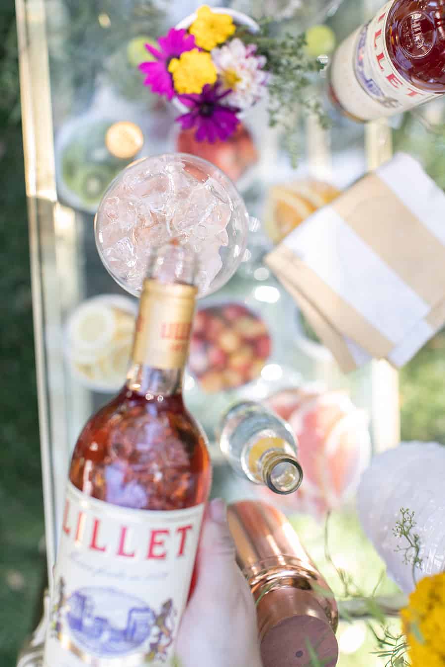 Lillet being poured in a glass over ice