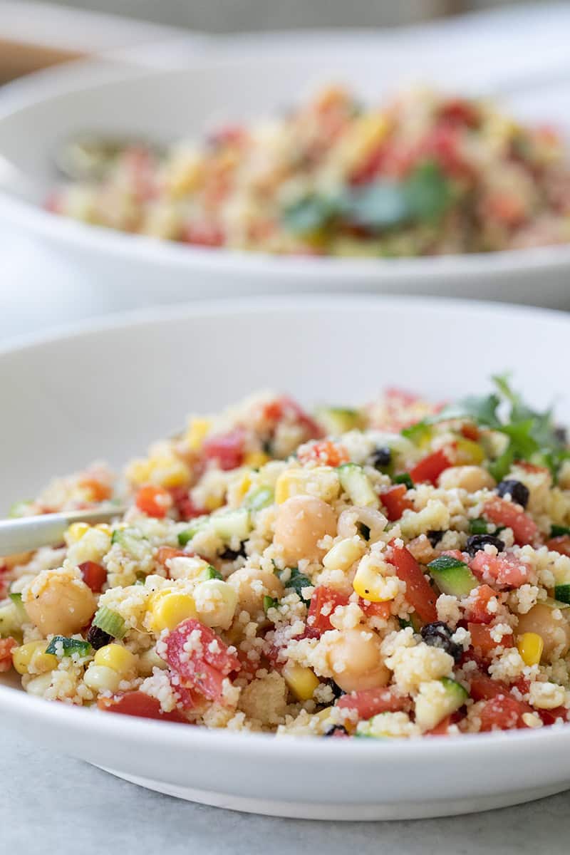 Close up picture of couscous salad with vegetables. 