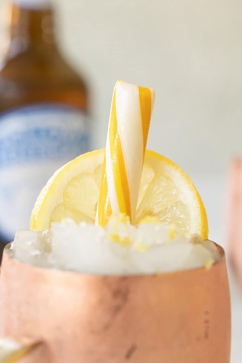 Close up photo of a classic lemon stick in a Moscow Mule.