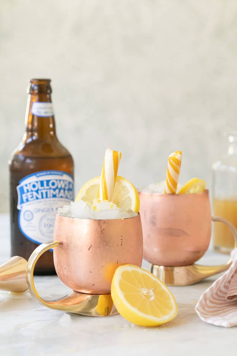 Lemon Mules in a copper mug with a lemon candy and ginger beer.