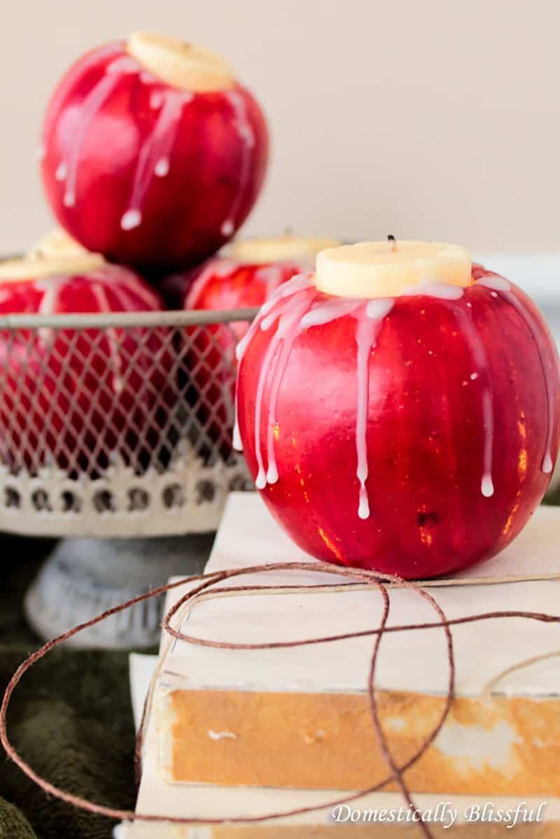 Red apple with a candle in the center for Halloween party idea