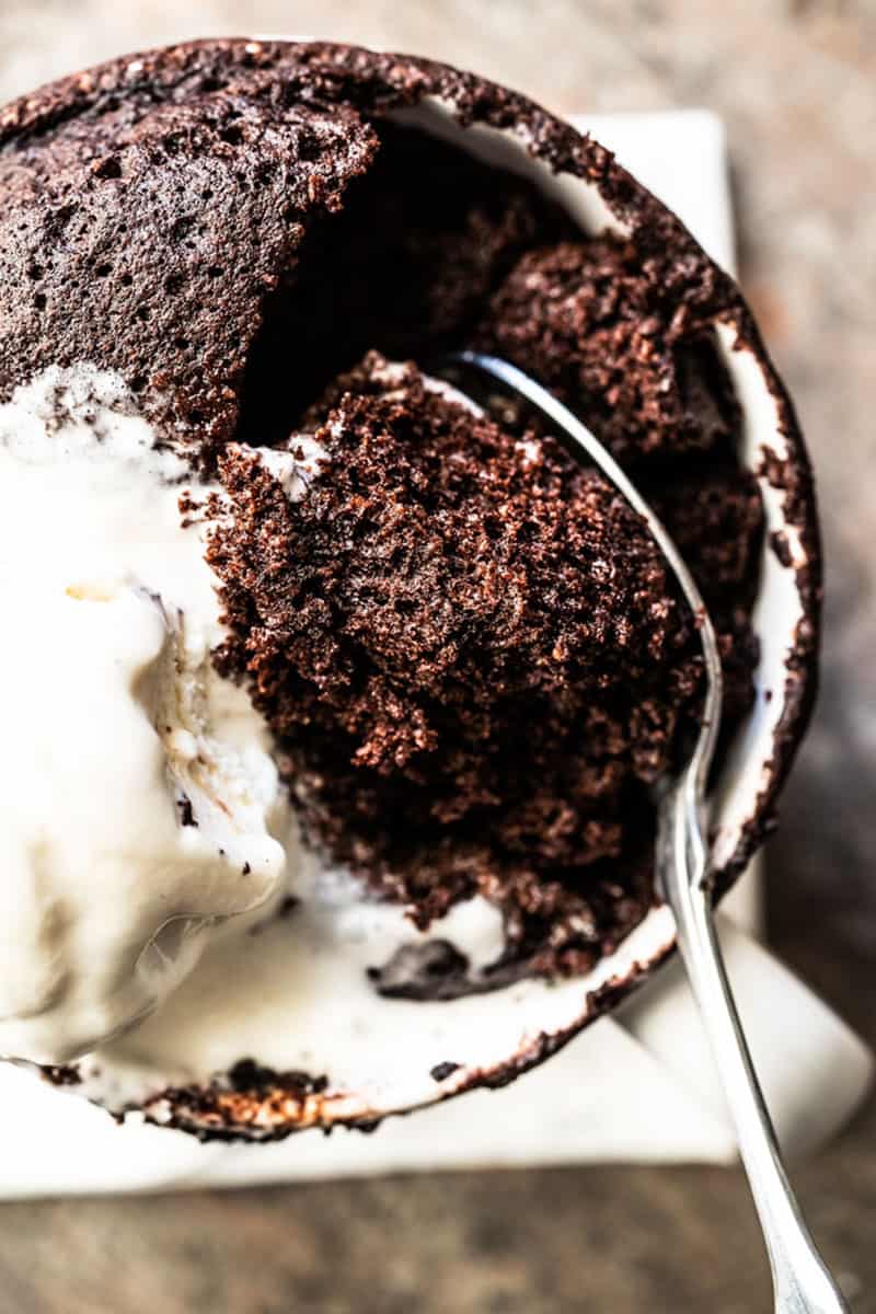 Chocolate mug cake with spoon in the center.