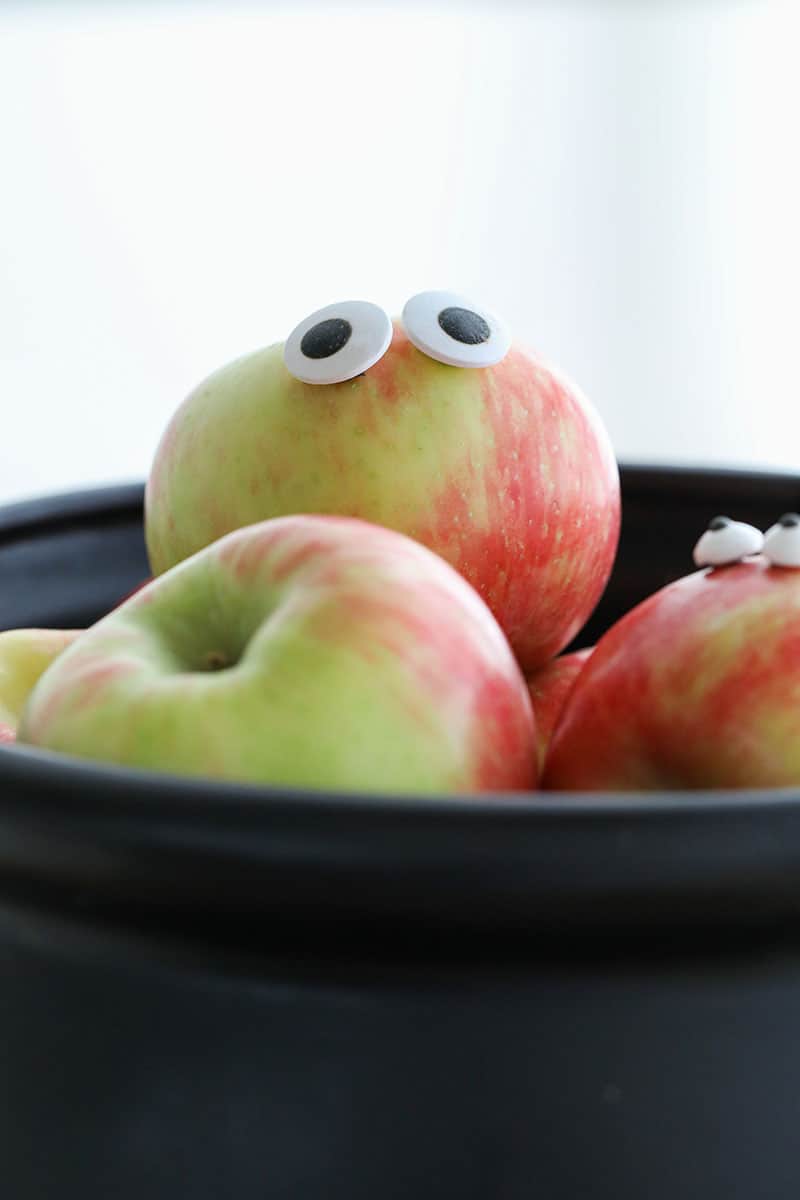 Adding eyes on apples for a Halloween trick or treat party.