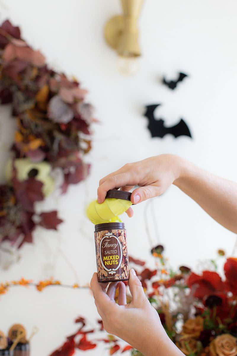 Opening a can of fake peanuts for a Halloween party