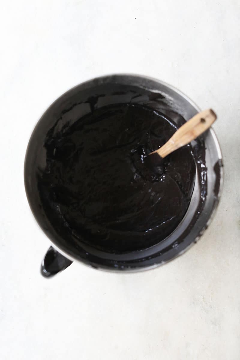 black velvet cake batter in a mixing bowl on marble table - black cocoa powder, moist black velvet cupcakes, dark cocoa powder