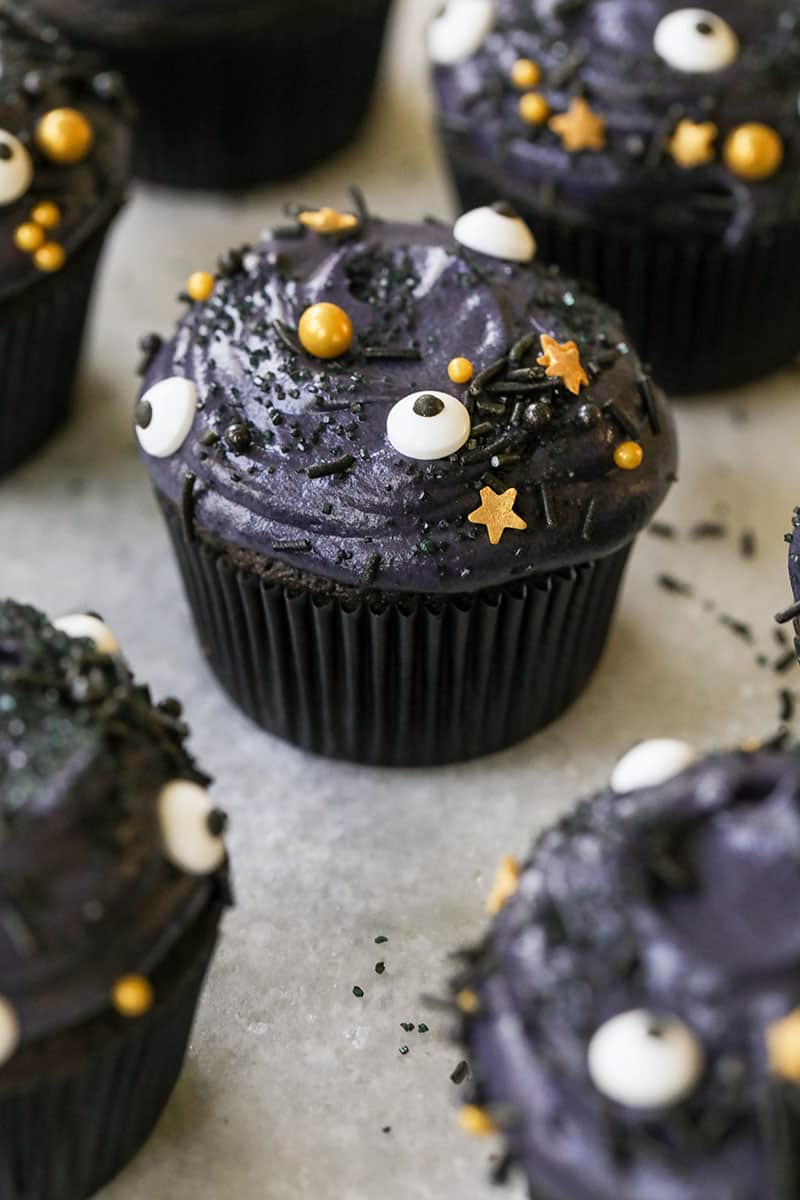 Spooky black velvet cupcakes with eyeball sprinkles and gold starts with a black cupcake liner - black cocoa powder