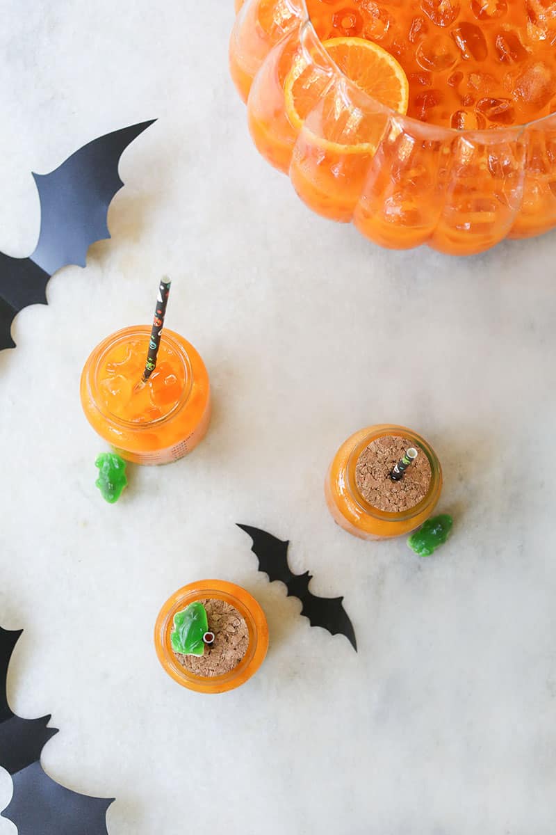 Halloween orange punch on a marble table with bats.