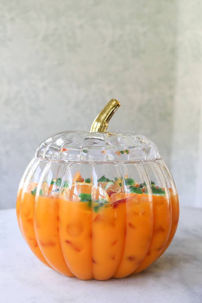 Orange Halloween punch in a pumpkin bowl. 