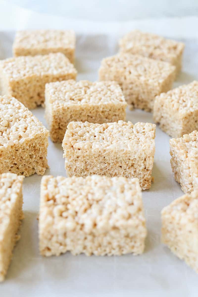 Brown butter rice Krispie Treats cut into rectangles on parchment paper. 