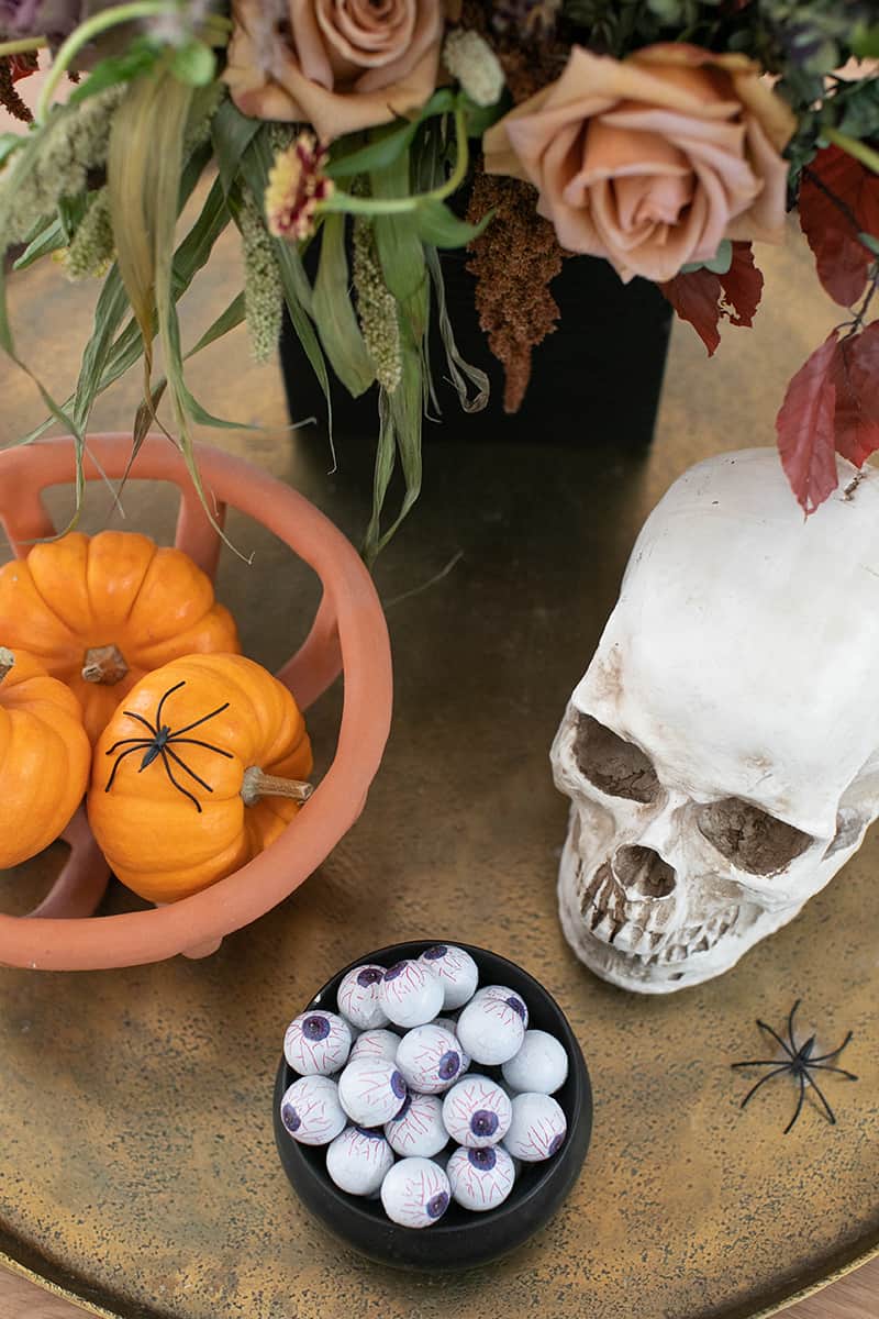 Skull, flowers and candy eyes on a gold tray - spooky season, halloween countdown calendar, halloween candy